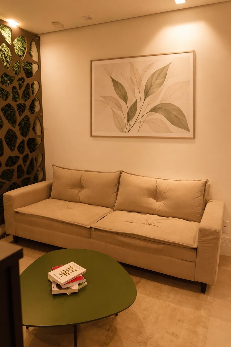 Sala de espera com sofá e painel verde
